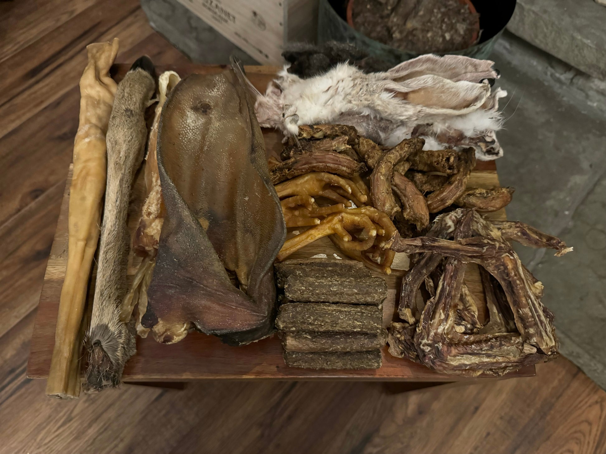 Spooky Halloween dog treat box deer legs, chicken feet and necks, duck wings, chewy beef tendons, buffalo ears, goat rolls, sausages, rabbit ears. 