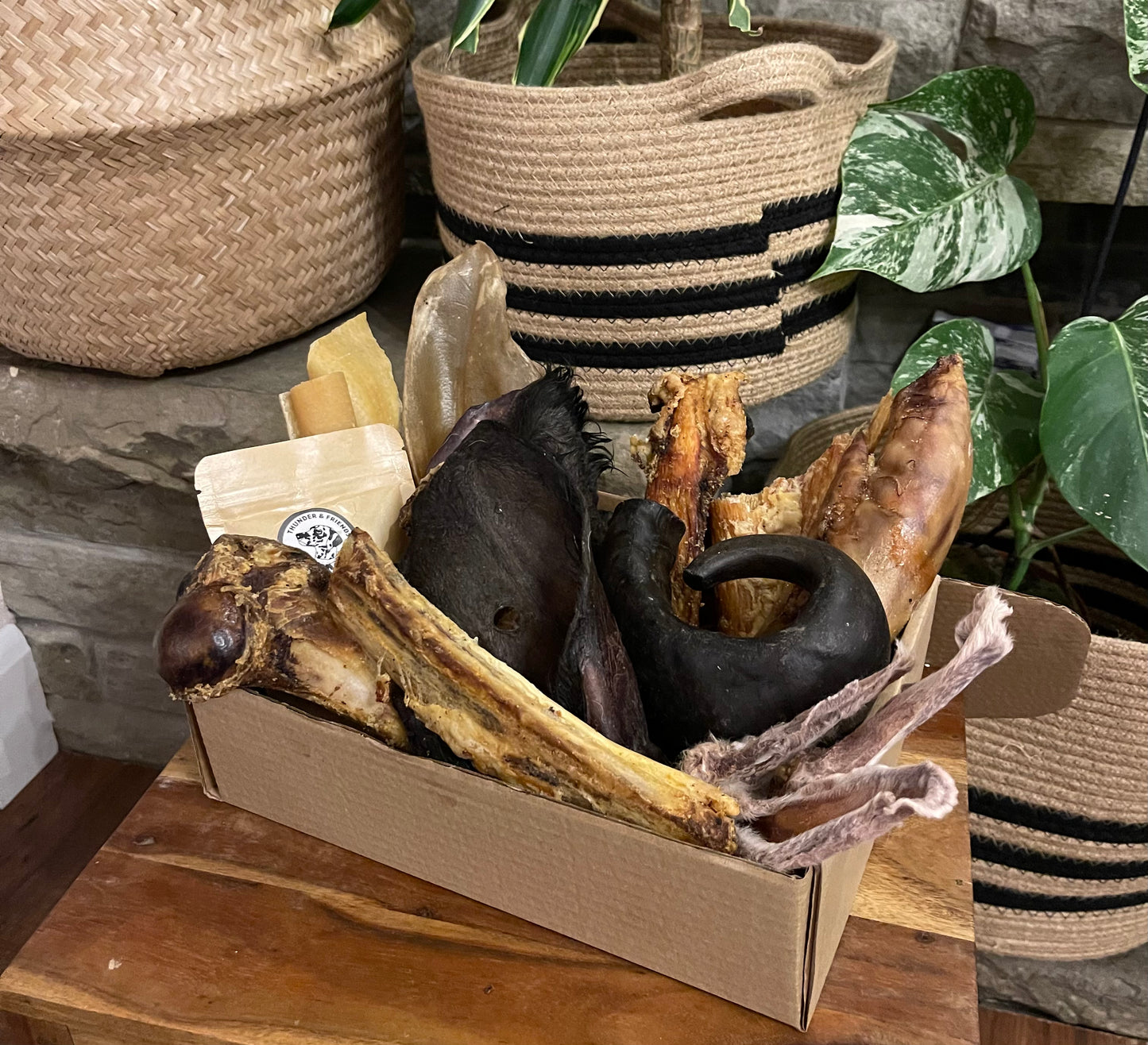 Natural dog treat subscription box with rabbit ears, bones, cow ears, cow hooves, paddywacks, lamb trotters, tracheas, buffalo horns and other goodies. 